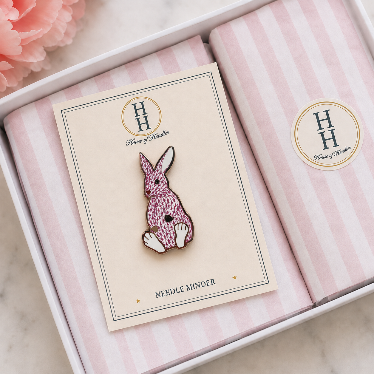 A Palm Bunny Pink needle minder packaged in its House of Hendler gift box